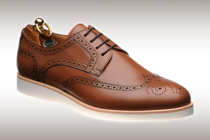 Tan brogue with white rubber sole known as the Jack II
